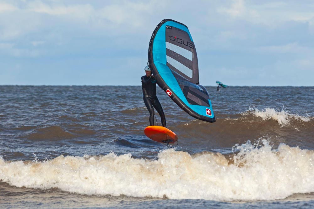 Portobello, Edinburgh, Scotland, UK. 27 September 2024. Good wind direction for wingfoiling or wind winging on the Firth of Forth just off of Portobello shore. NWN wind at around 20km/h. Pictured: Andy Brimelowe a GP from Leith enjoying putting his skill against nature on the choppy waters, temperature 12 degrees centigrade. Unusual to have board watersports on this beach apart from Paddleboarding as the wind is not normally blowing in a suitable direction.