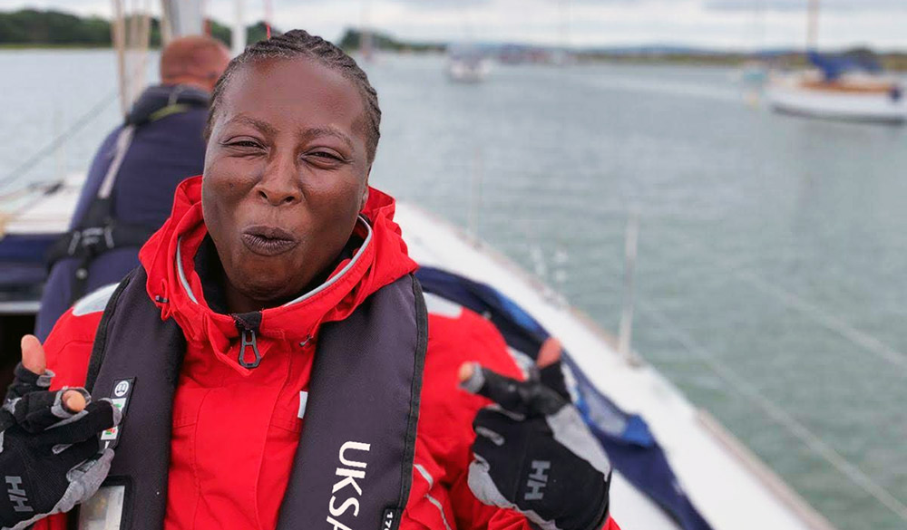 mid-shot of really happy women on a large yacht on the open water