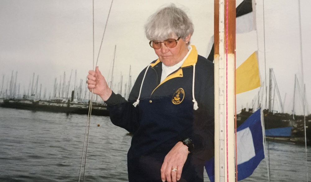 Mid shot of a woman on a boat with colourful flags